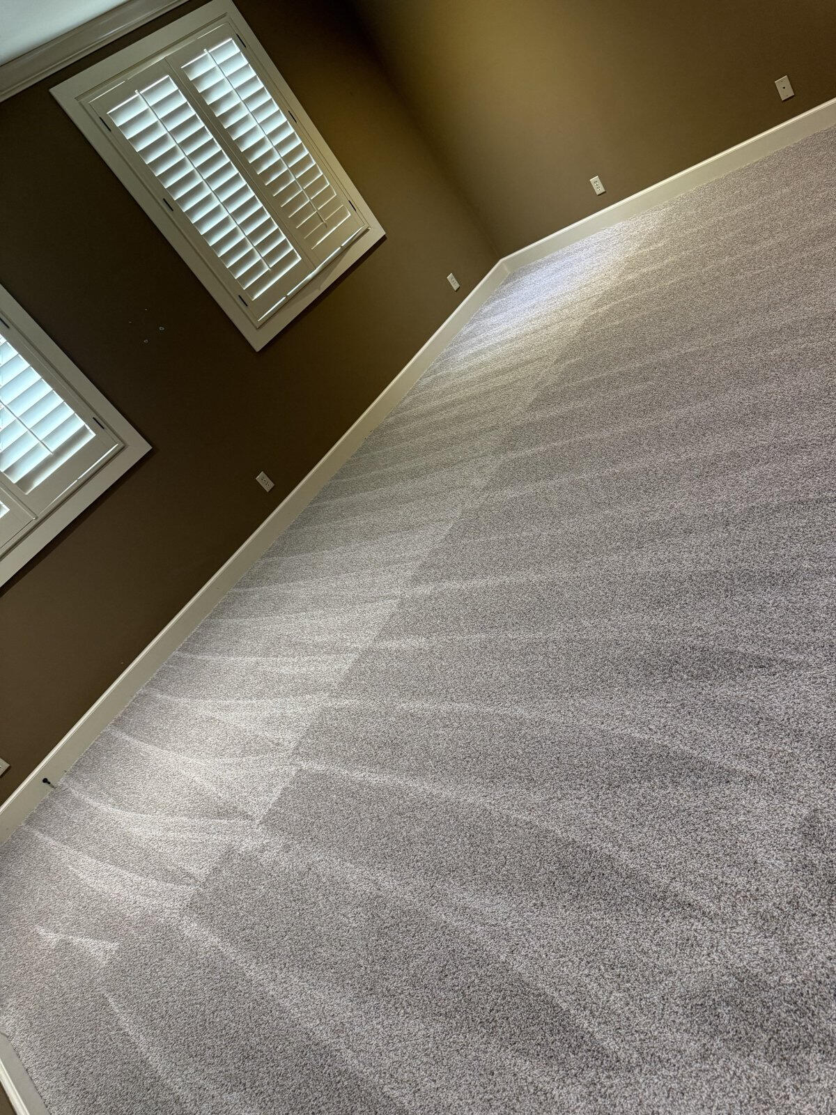 Freshly vacuumed carpet in an empty room after a move-out clean
